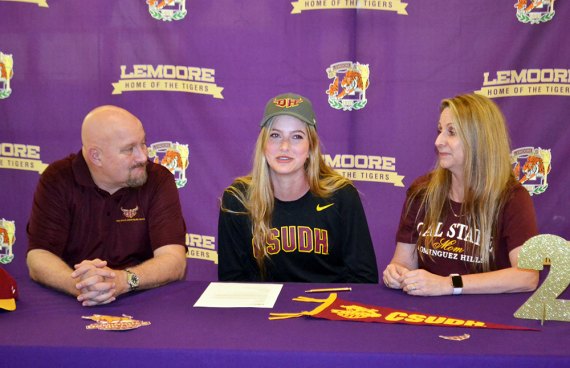 Shelby Saporetti, center, was joined by father Michael and mom Deanna Thursday morning in the Lemoore High School Event Center where she signed a letter-of-intent to play volleyball at Cal State Dominguez Hills.